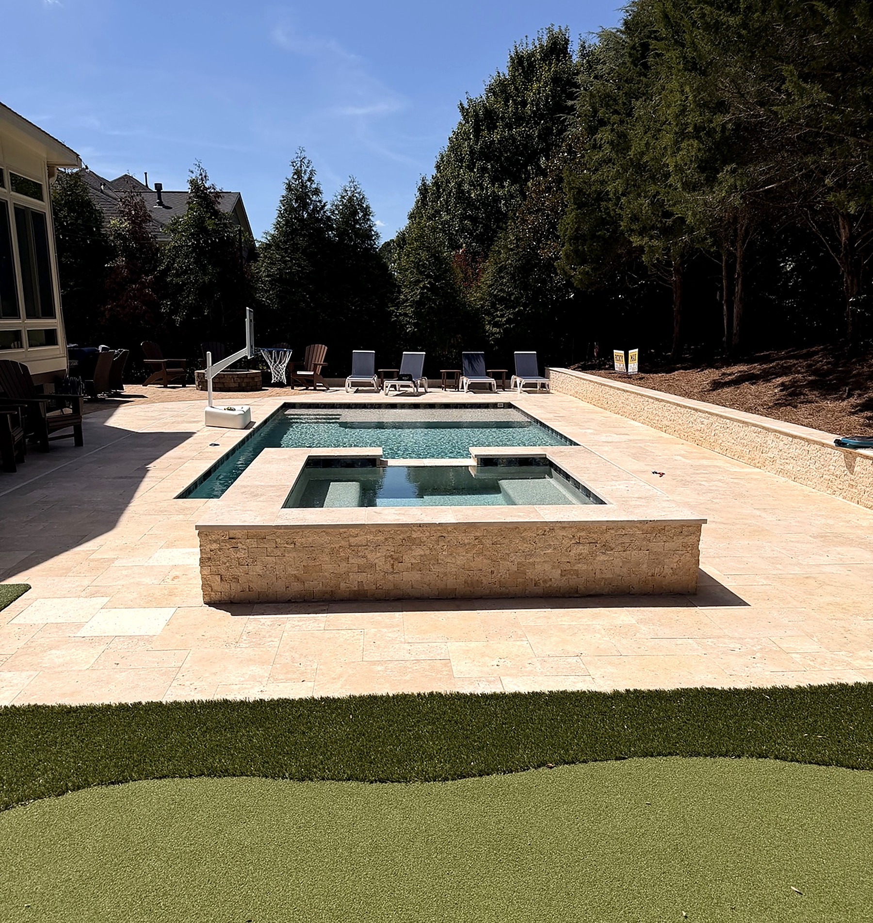 EMV custom swimming pool and elevated spa with stone patio