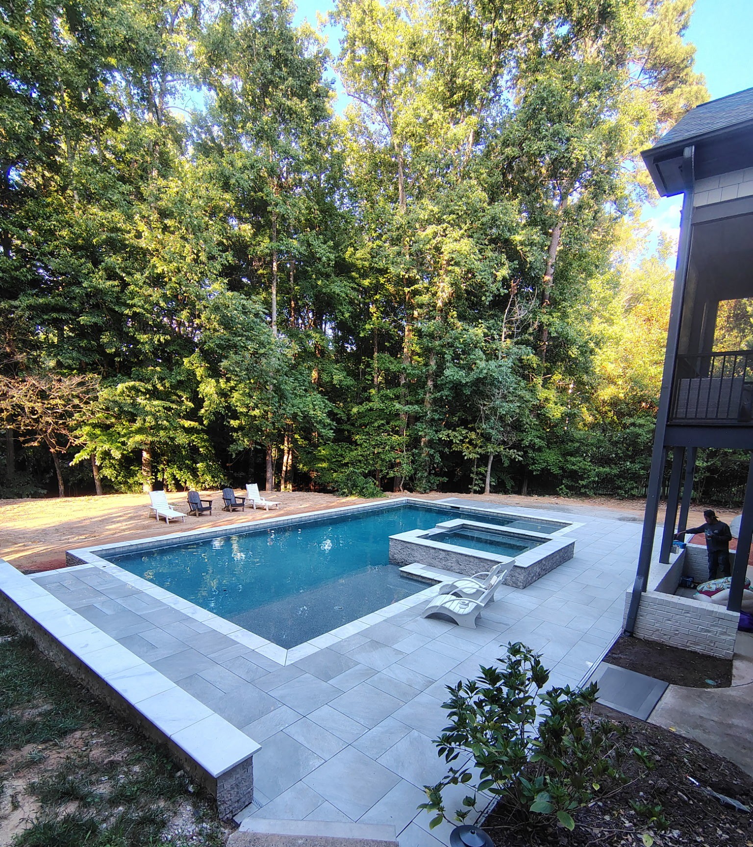 EMV modern blue pool, raised spa and patio installation